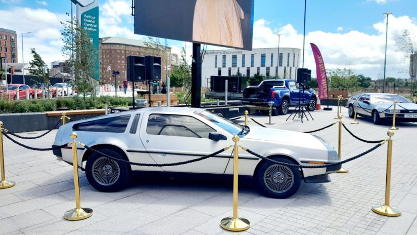 De Lorean cars with buildings in the background.